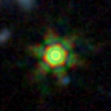 Colour composite: F444W red, F356W green, F277W blue, 3.2 arcsec across, north up
