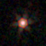 Colour composite: F444W red, F356W green, F277W blue, 3.2 arcsec across, north up