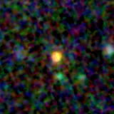 Colour composite: F444W red, F356W green, F277W blue, 3.2 arcsec across, north up