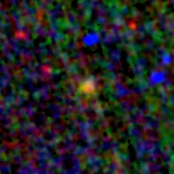 Colour composite: F444W red, F356W green, F277W blue, 3.2 arcsec across, north up